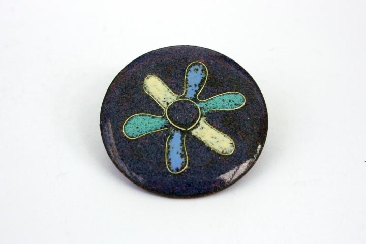 brooch with flower design on heather mix background